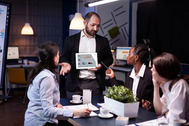 overworked businessman showing financial graphs presentation using tablet brainstorming company ideas