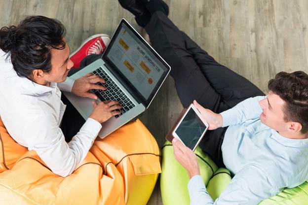 two business men working on tablet and laptop